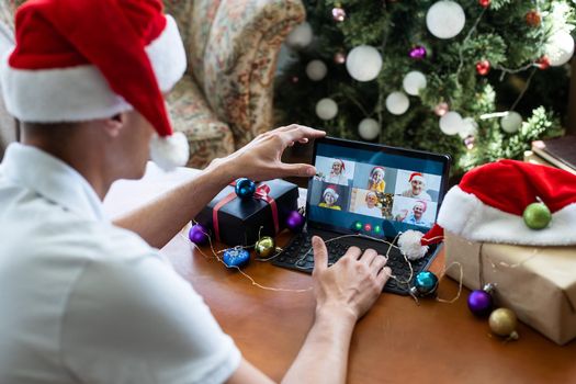 Man connecting with family during Christmas time online having video call