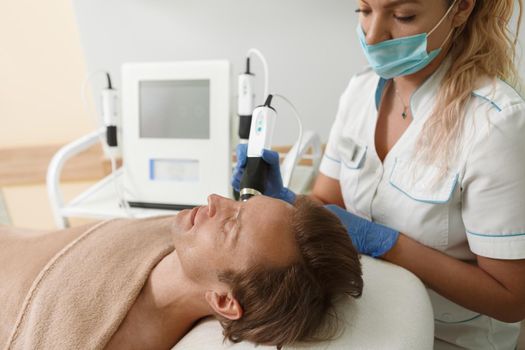 Cropped shot of a beautician in medical face mask working during coronavirus pandemic