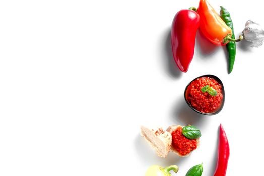 Ingredients for cooking Ajvar sauce. Place for the text. Ajvar is a locally known red pepper and eggplant seasoning that is produced in the Balkans - Turkey, Serbia, Montenegro, Albania and is vegan