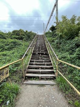 Old metal stairs outdoors under gloomy grey sky