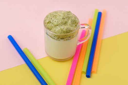 Dalgona Matcha Latte, pink background. Matcha green tea. Trendy drink. Superfoods. Dairy beverage. Korean drink