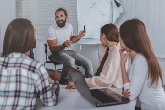 Diverse group of creative businesspeople discussing their project at business meeting. Mature businessman talking to colleagues at the office. Creativity, achievement, success concept