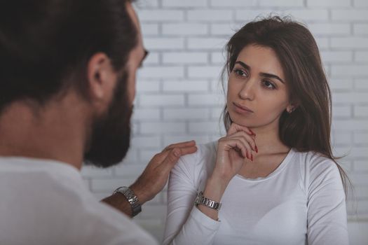 Attractive young businesswoman getting an advice from her experienced male colleague at work. Business people discussing dtartup project together. Lovely woman looking at her co-worker thoughtfully