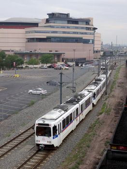 Devner - July 7, 2015: RTD The Ride Electric Trains moves along tracks on cloudy day.