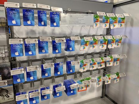 Honolulu - August 19, 2019:  Apple Itunes App Store and Google Play Gift Cards on display on rack at Best Buy.  