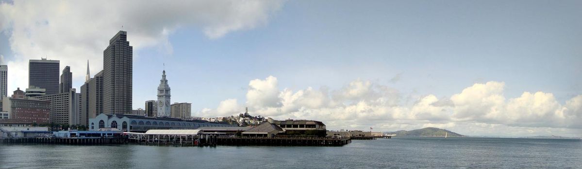 San Francisco - March 25, 2010:  Port of San Francisco Ferry building and cityscape of Downtown in the background.  Panoramic Taken from a ferry departing