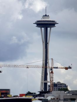 Seattle - June 24, 2016: Skyscraper under construction and the Space Needle in Seattle, Washington, USA clouds in the sky. 