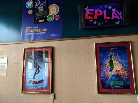 Kona, Hawaii - October 19, 2018: Inside Regal Cinemas Makalapua 10 with Spider-Man and Grinch Movie Posters and Mobile App ad on wall in Hallway.   