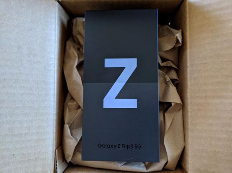 Honolulu - August 27, 2021: Brand new Samsung Z Flip3 5G still in box in opened brown box.