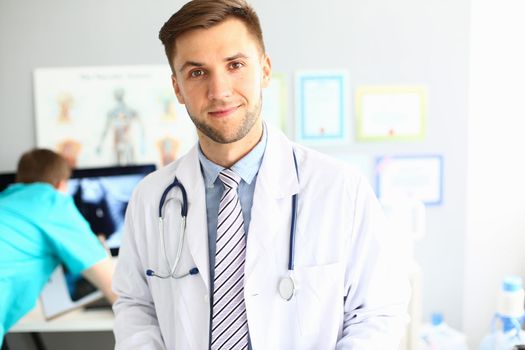 Young confident male therapist doctor cardiologist portrait. Successful doctor career and health insurance concept