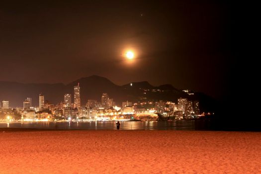 Benidorm, Alicante, Spain- September 11, 2022: Beautiful panoramic view of Benidorm town on a full moon night