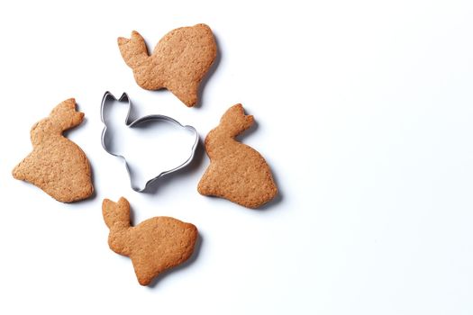 Ready-made Christmas cookies in the form of a rabbit with a cookie cutter isolated on a white background. copy space.