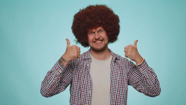 I am the best. Happy satisfied selfish haughty man proud of his victory, bragging own success win achievements, pointing fingers on himself with smile. Young adult guy boy on blue studio background