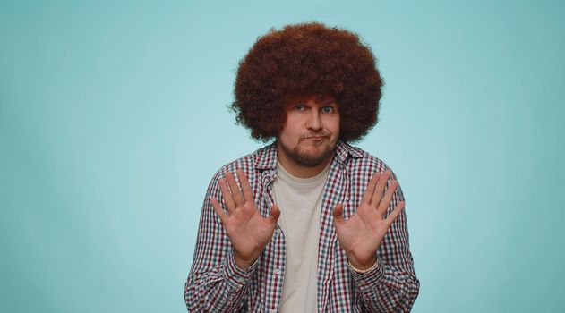 I am not guilty. Handsome bearded man with lush hair coiffure pointing fingers himself ask say who me no thanks i do not need it. Young adult guy boy isolated alone on blue studio wall background