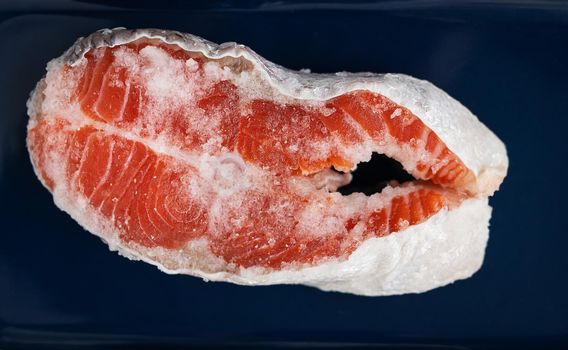 Fresh raw red salmon steak with large coarse pink salt prepared for grilling. Healthy seafood food. Healthy food