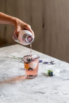 cold refreshing tea with blueberry, lime and lavender on a hot summer day on a wooden table. High quality photo