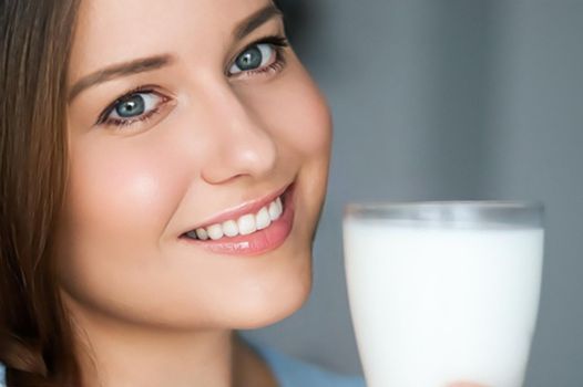 Diet and wellness, young woman with glass of milk or protein shake cocktail, portrait