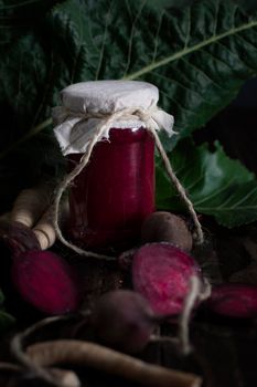 appetizer of beetroot and horseradish still life on a wooden table, seasonal twists and food preservation for the winter, photo in a dark key. High quality photo