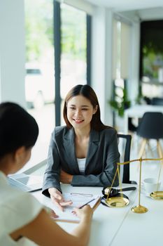 Law and legitimacy, portrait of lawyer and client signing important contract documents.