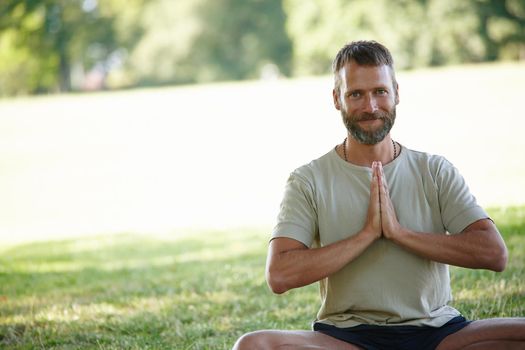Yoga works for me. Cropped portrait of a handsome mature man doing yoga outdoors