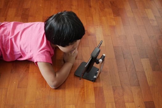 child hand pointing finger on digital tablet screen