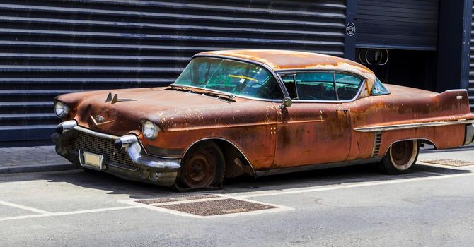 Shot of abandoned, rusty, vintage car.