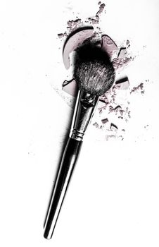 Beauty texture, cosmetic product and art of make-up concept - Brush with crushed eyeshadow and powder close-up isolated on white background