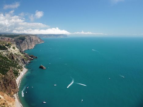 Aerial boat race. Luxury cruise trip. View from above of white boat on deep blue water. Aerial view of rich yacht sailing sea. Motor boat racing wave. Summer journey on luxury ship