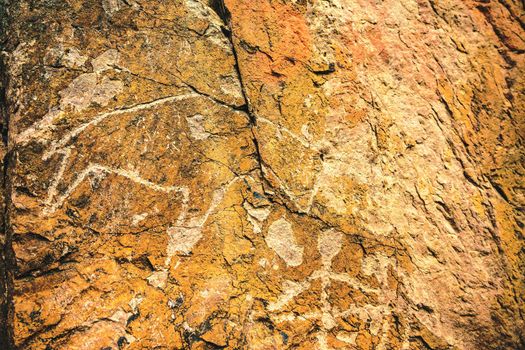 Archaeological rock petroglyphs of animals and people in the tract Tamgaly tas or Tanbaly tas in the Almaty region of Kazakhstan. UNESCO World Heritage.
