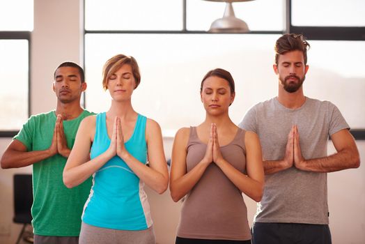 Yoga helps you reach your sacred self. A group of people doing yoga together