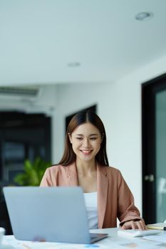 Portrait of a beautiful young woman working on a computer