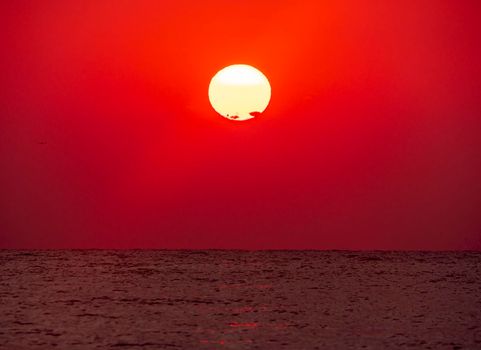 big sun down over sea sunrise, red sky