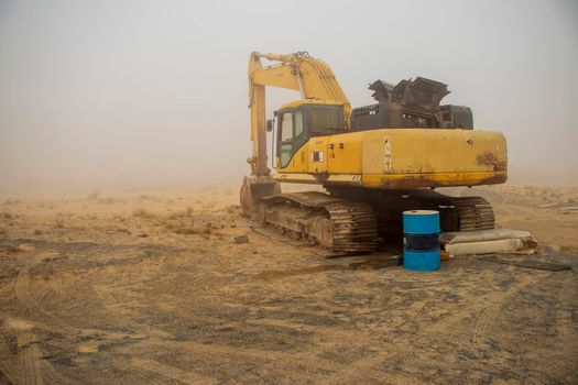 Excavator in the deserted road on the foggy morning, Outdoors