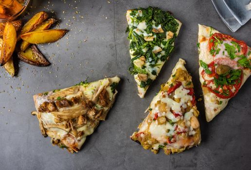 Assorted handmade Argentinian pizza on stone background