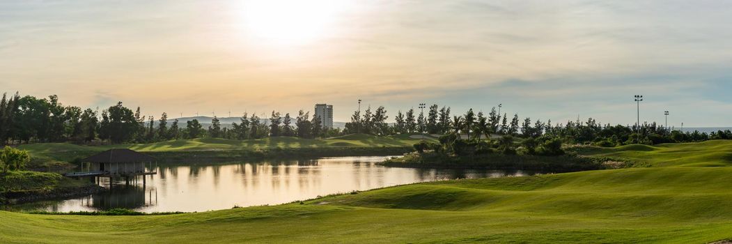 BANNER LONG FORMAT, crop it. Orange dawn sun golf pond reflection hills green fabulous background.