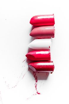 Beauty texture, cosmetic product and art of make-up concept - Cutted lipstick close-up isolated on white background