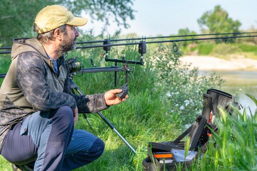 fishing session in the ebro river adult man with beard carp fishing