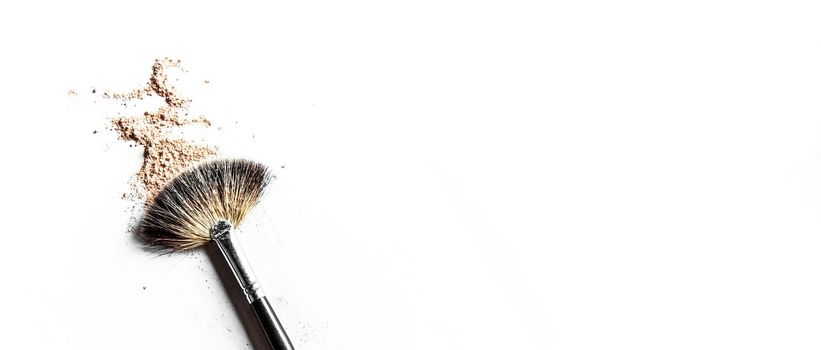 Beauty texture, cosmetic product and art of make-up concept - Brush and beige powder close-up isolated on white background
