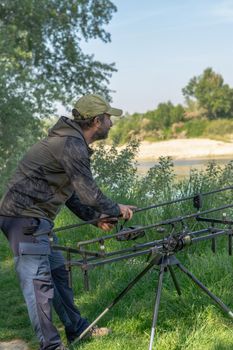 fishing session in the ebro river adult man with beard carp fishing