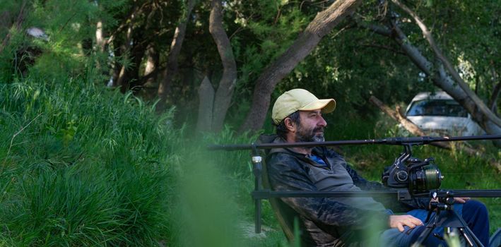 fishing session in the ebro river adult man with beard carp fishing