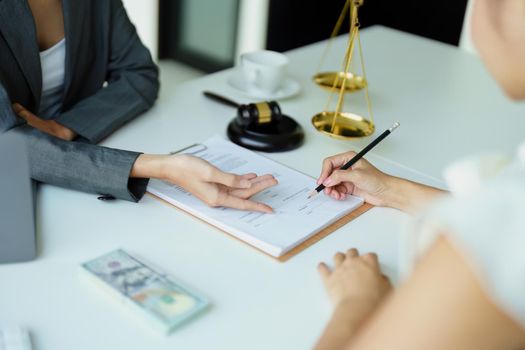 Law and legitimacy, portrait of lawyer and client signing important contract documents.