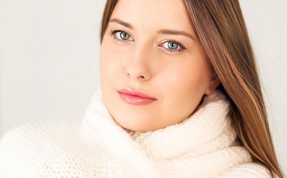 Autumn winter fashion and knitwear, beautiful woman wearing warm knitted scarf, close-up portrait