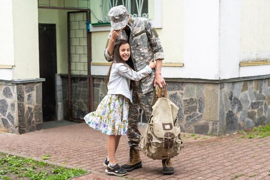 Happy little girl having fun with her military father.