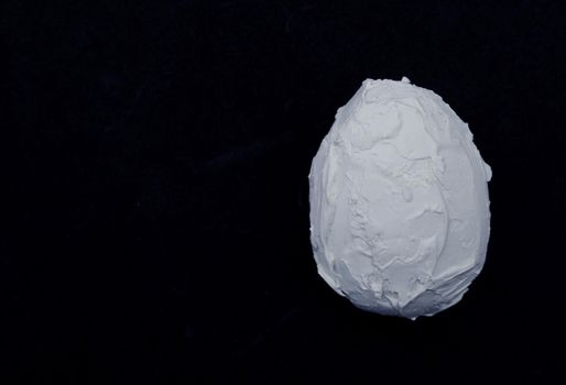 White decorative egg covered with white plaster.