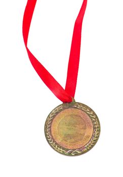 Gold medal with a red tape isolated on white.