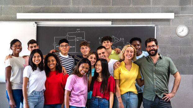 Multiracial teen high school students group class portrait with teacher looking at camera. Education concept.