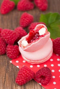 Macaroon with raspberries cookies on a wooden table