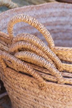 Stack of handmade wicker baskets close up background