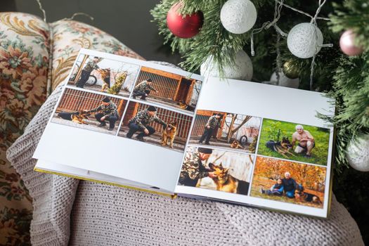 family photo book near the Christmas tree.