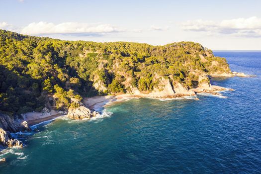 coastline with rocks, virgin coves and sea cliffs covered with trees and vegetation, concept of adventure lifestyle and water sports in summer holidays in the wilderness